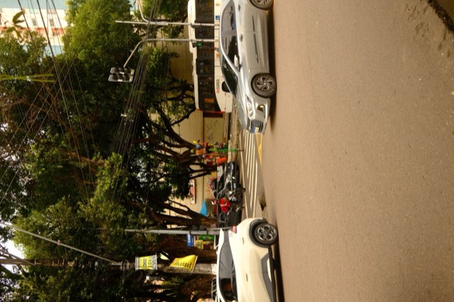 Stilt performer at a busy junction from Max Nicholson's archive