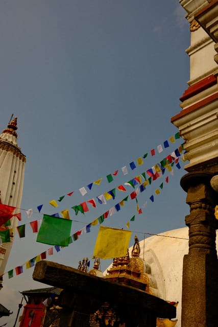 Prayer flags between temple towers from Max Nicholson's archive