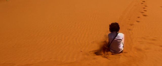 Sandboarding down a dune from Max Nicholson's archive