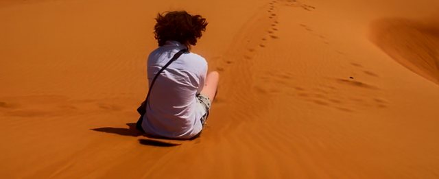 Sandboarding beside a trail of footprints from Max Nicholson's archive