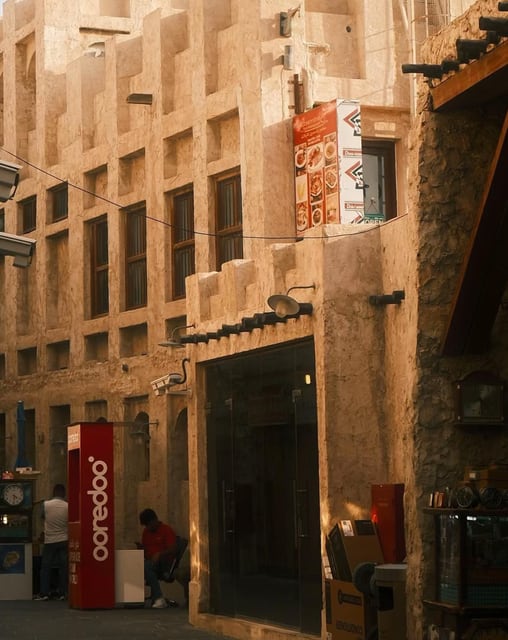 Shops beneath sand-colored walls from Max Nicholson's archive
